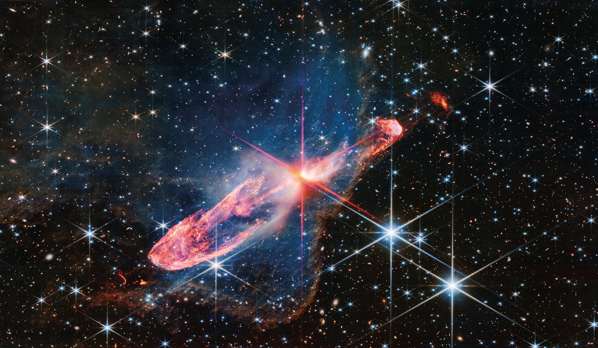 Фото, сделанное Уэббом в ближнем инфракрасном свете с высоким разрешением тесно связанной пары активно формирующихся звёзд, известной как Herbig-Haro 46/47