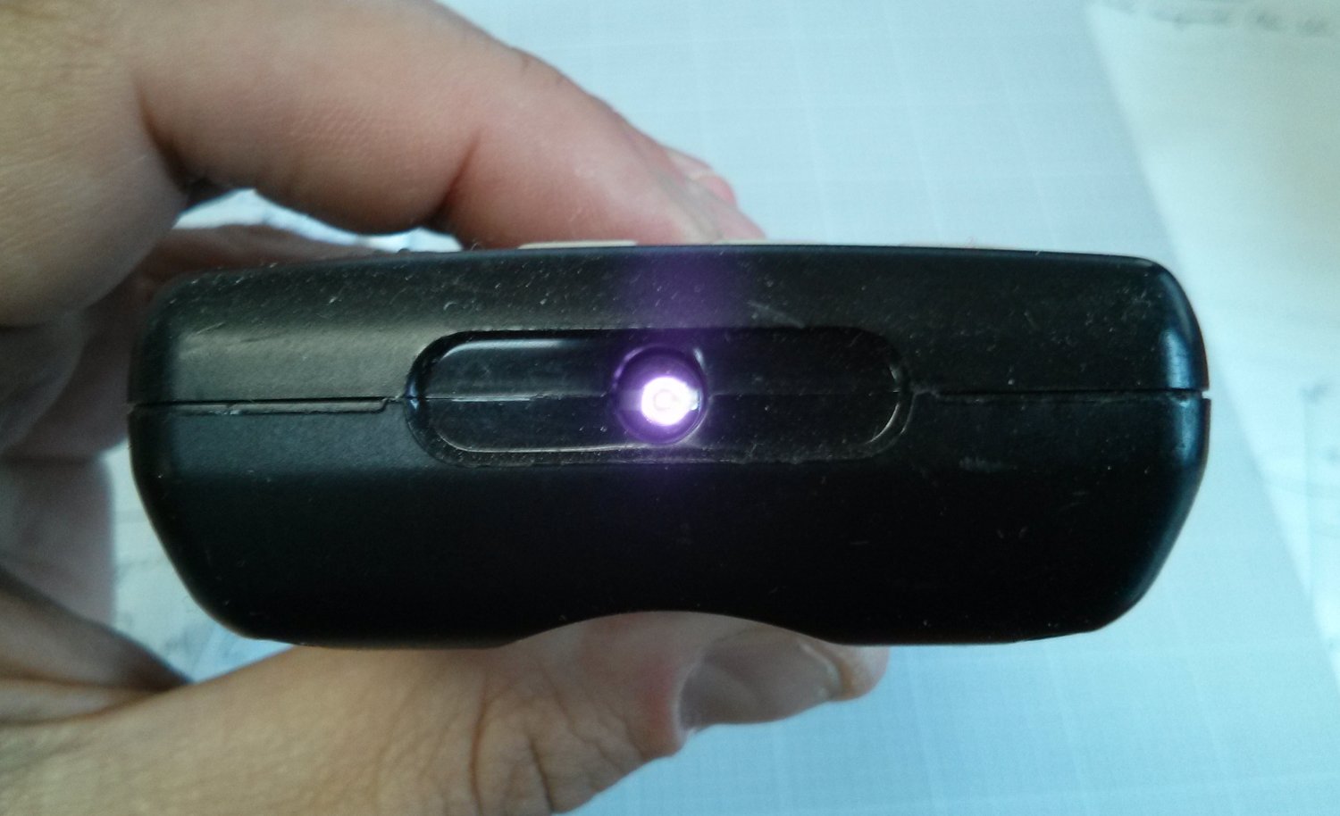The IR LED on the remote turns purple on the camera.  Source.