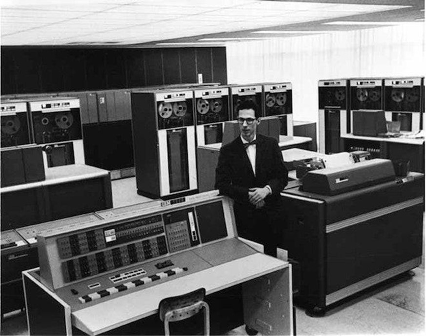 Фернандо Корбато на фоне компьютера IBM, для которого написал систему разделения времени с паролями для пользователей © MIT Museum