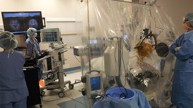 Neurosurgical operating room.  The previous generation system is in the left third of the image.